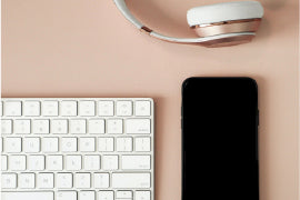 keyboard cellphone and headphone placed on table for podcast events